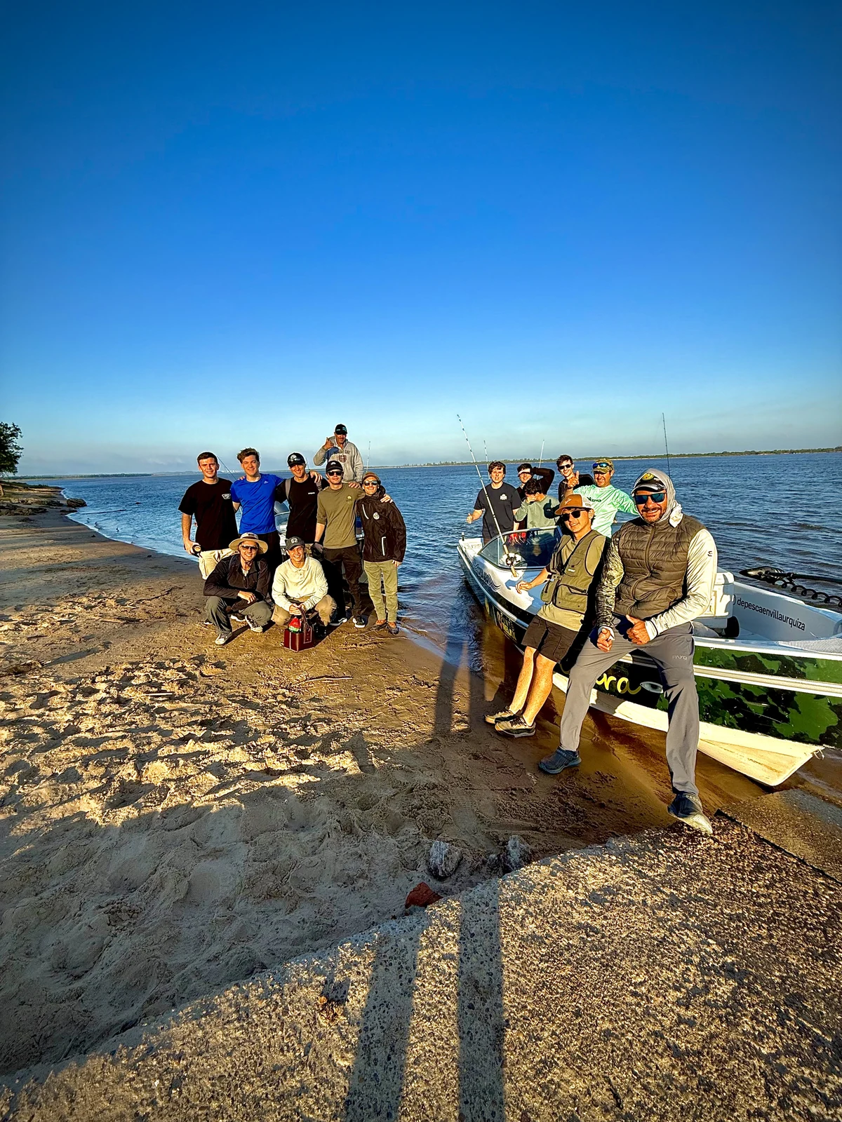Grupo de pescadores junto a las embarcaciones en una isla del río Paraná, en Villa Urquiza